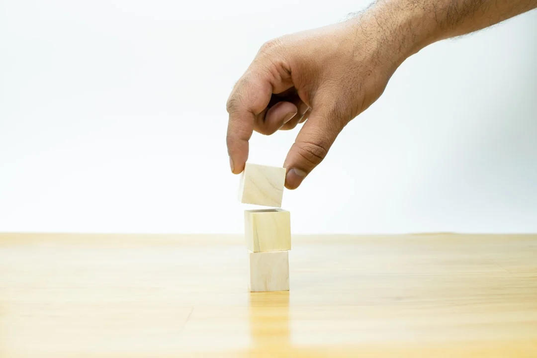 A smart speaker set on a wooden surface with a softly blurred background, highlighting its clean, minimalist design.